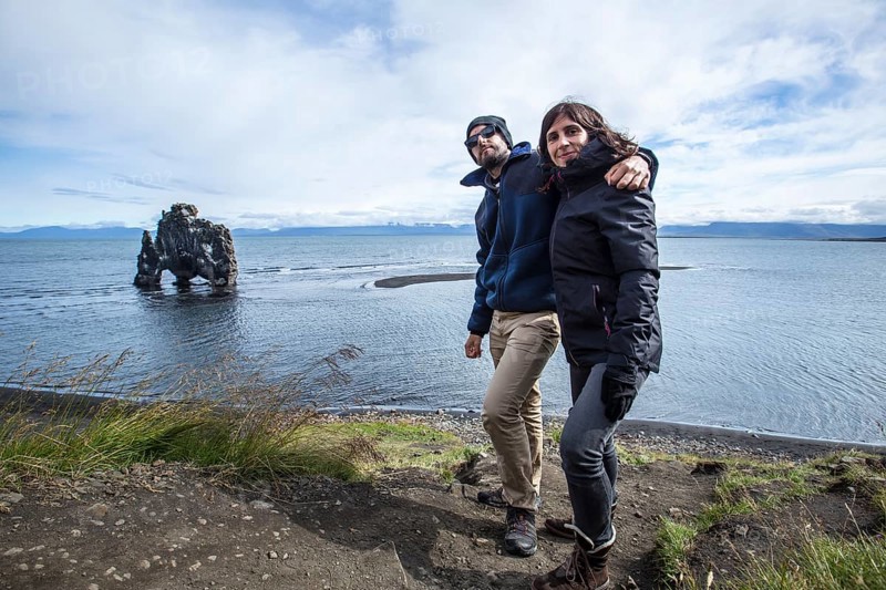 A couple in stone dinosaur in the sea at Hvitserkur