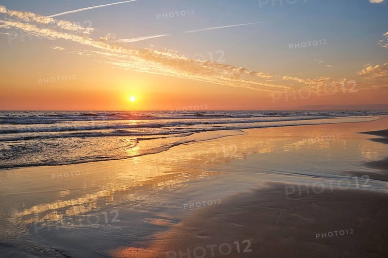 Atlantic ocean sunset with surging waves at Fonte da Telha beach