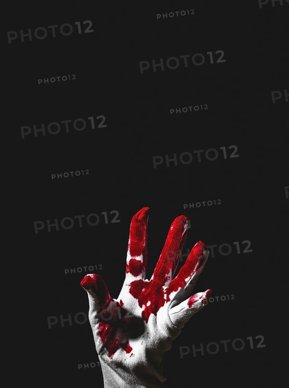 Reaching up hand in white glove with blood stains