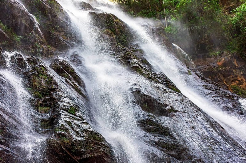 Beautiful waterfall with water flowing between the rocks and the forest in Minas Gerais