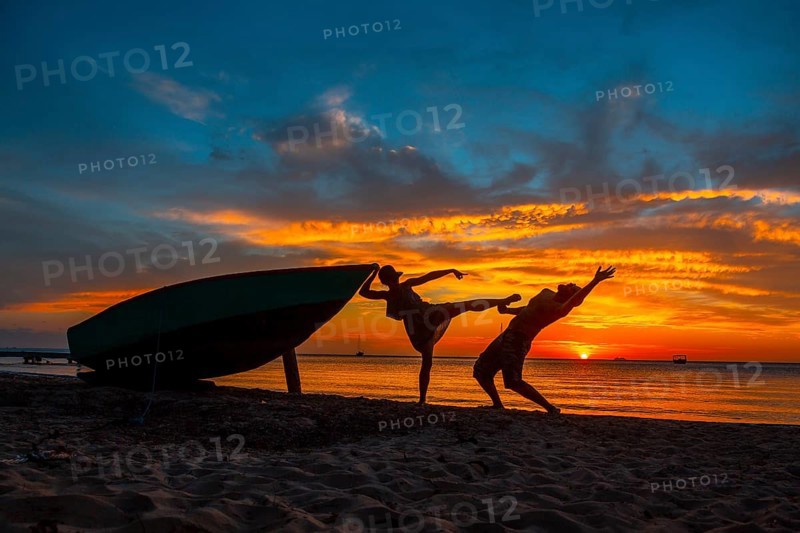 A couple playing at Roatan Sunset from West End. Honduras