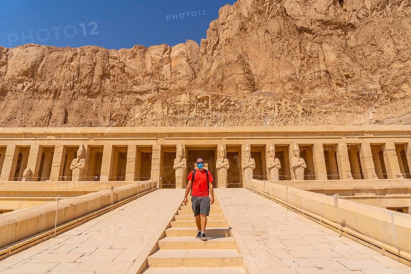 A young woman on the entrance stairs to the Funerary Temple of Hatshepsut in Luxor. Egypt