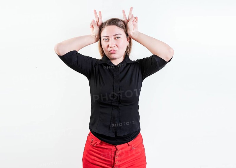 People making horns gesture with their fingers
