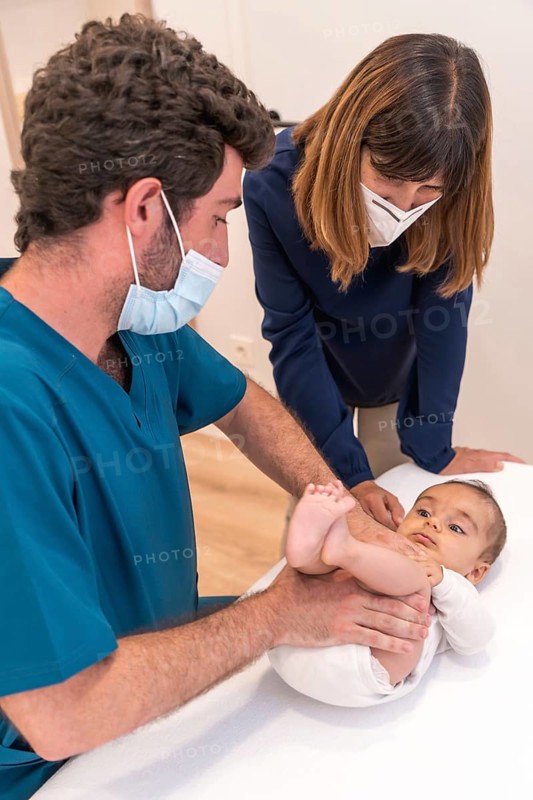 Vertical photo of a mother and baby during a checkup in the hospital