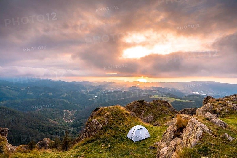 Wild camping on the top of a mountain at sunset