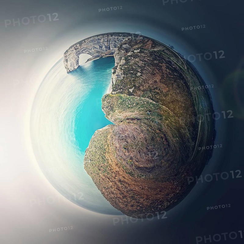 Sightseeing panoramic view to the Porte d'Aval arch cliff as a micro planet in space. Ocean waters continental side of Etretat