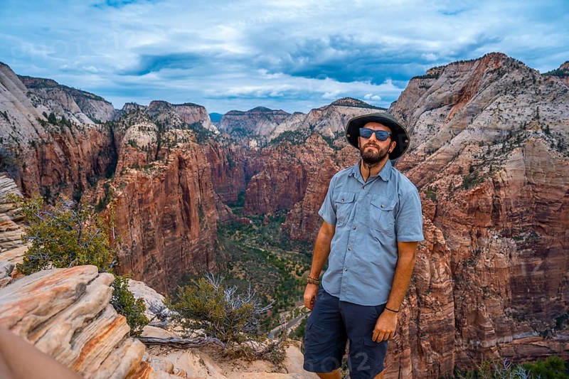 A man enjoying the views of Zion from the Angels Landing Trail in Zion National Park