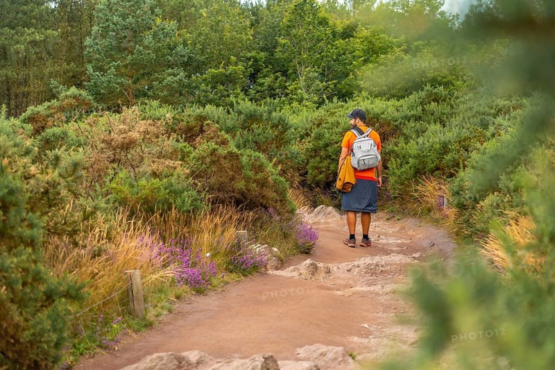 A young man on the footpath in the Broceliande forest