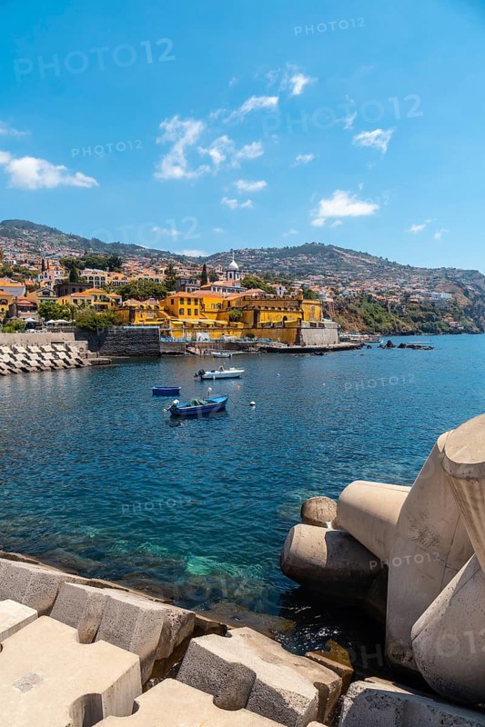 Small fishing boats next to the Forte de Sao Tiago on the beach of Funchal