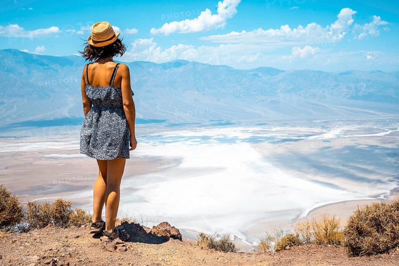 A young woman in dress on the beautiful viewpoint of Dante's view in Death Valley
