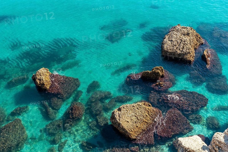 Detail of the sea and rocks on Calahonda beach in the town of Nerja