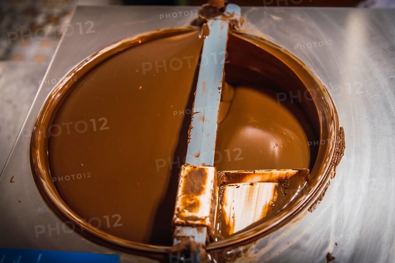 Making the liquid Natural Chocolate Cocoa circling on Roatan Island. Honduras
