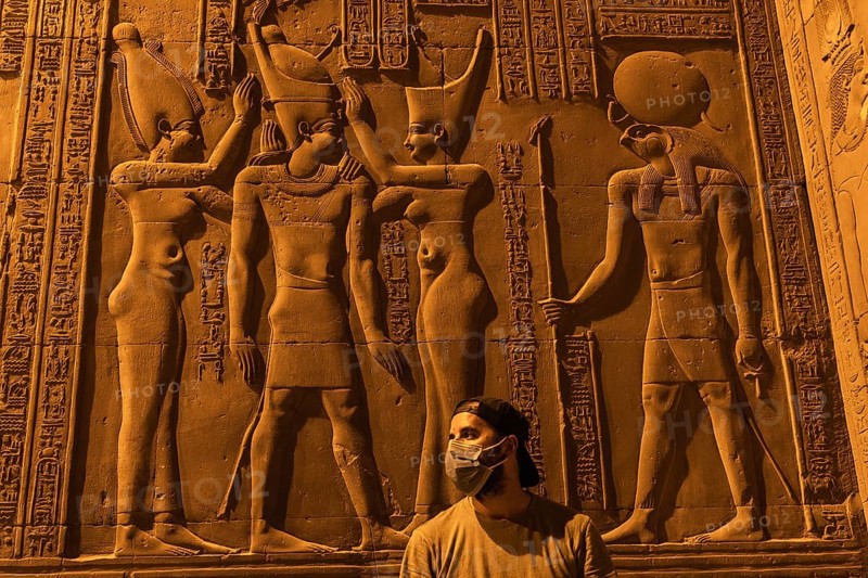 A young man visiting the beautiful temple of Kom Ombo at night