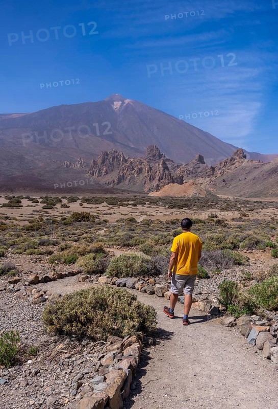 A young tourist on the volcano trekking trail at the Llano de Ucanca viewpoint in the Teide Natural Park in Tenerife