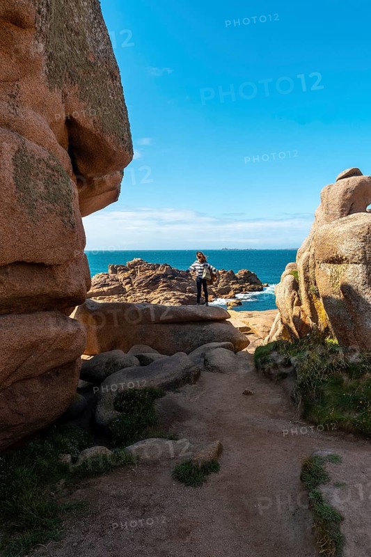 A young woman looking at the sea along Lighthouse Mean Ruz