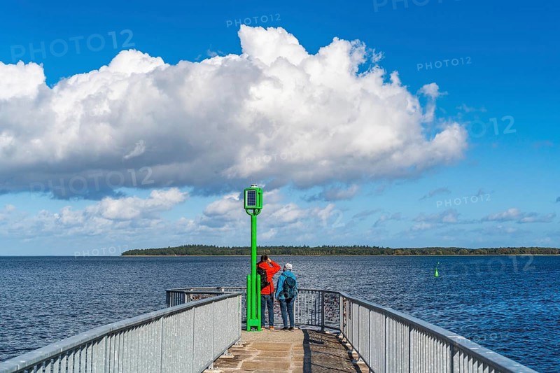 People on the pier at the Utkiek lookout in the fishing village of Wieck with a view over the Greifswald Bodden