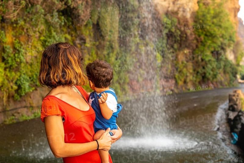 A mother with her son on vacation at Anjos Waterfall