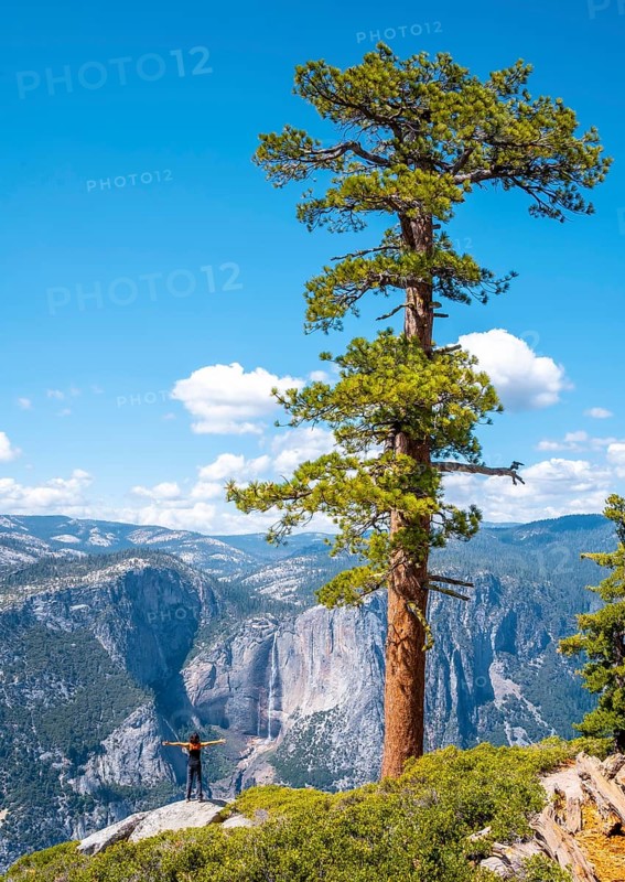 A young woman in Sentinel Dome looking at Upper Yosemite Fall