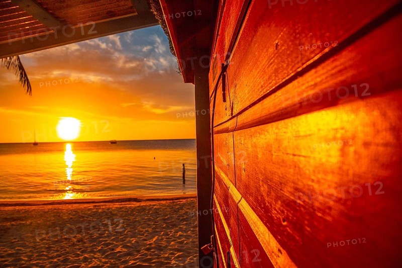 A wooden house at Sunset from West End Beach