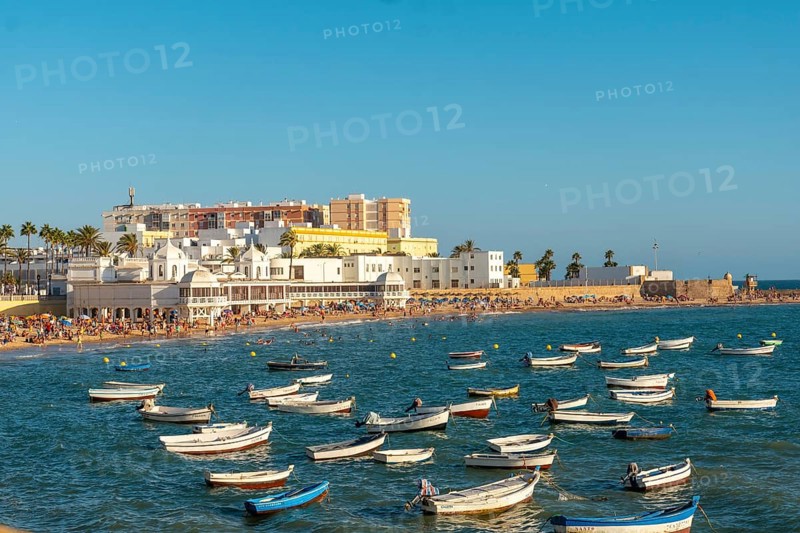 La Caleta beach full of tourism in the summer sunset of the city of Cadiz. Andalusia