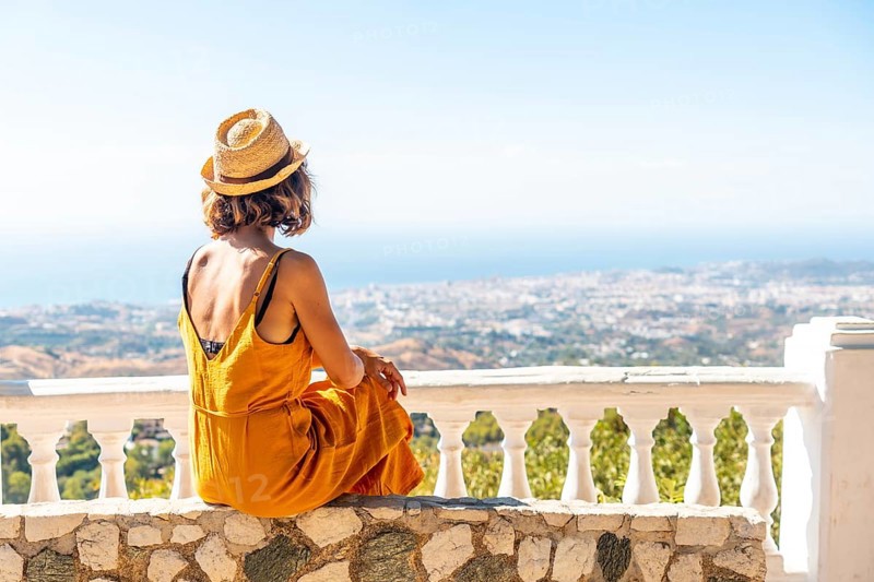 A young woman looking from the viewpoint in the municipality of Mijas in Malaga. Andalusia