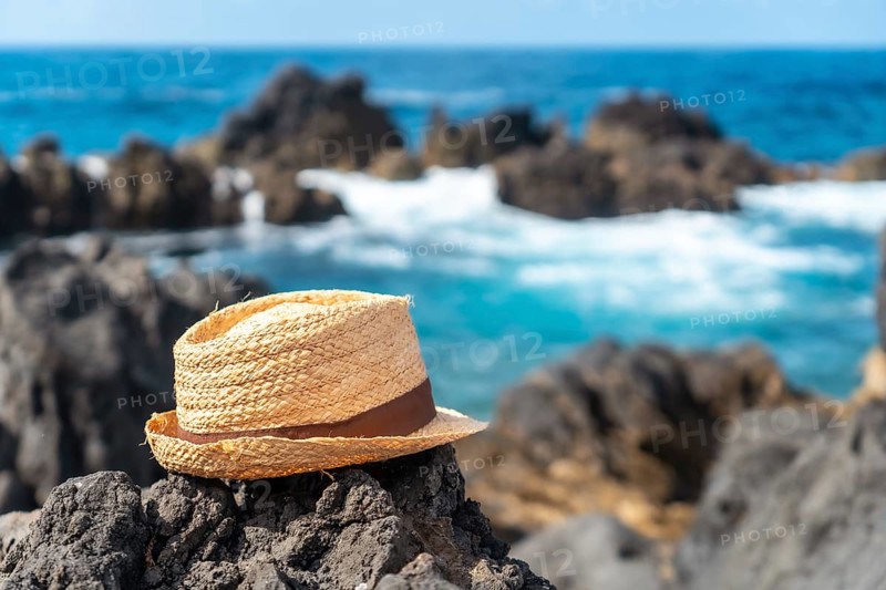 Hat next to a natural pool in summer