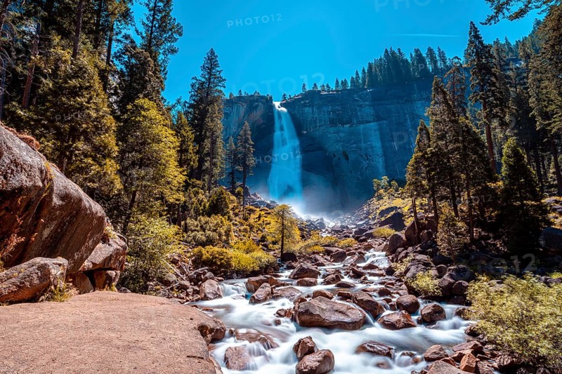 Landscape of Vernal Falls from the bottom one summer morning and the sun above. California
