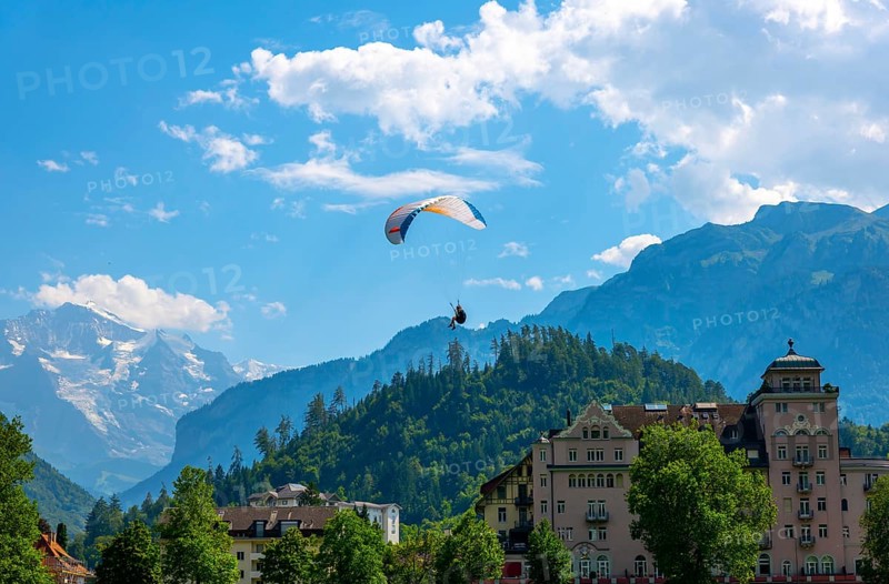 Paragliding in Front Of Snow Capped Jungfraujoch Mountain in a Sunny Day in Interlaken