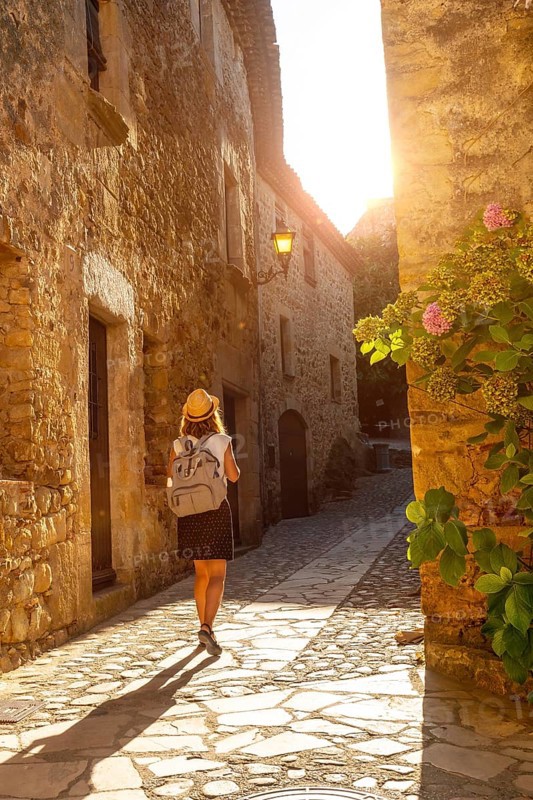 A young tourist walking in Pals medieval town