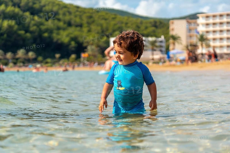 A little boy enjoying the summer on the beaches of Ibiza on holiday at San Vicente beach