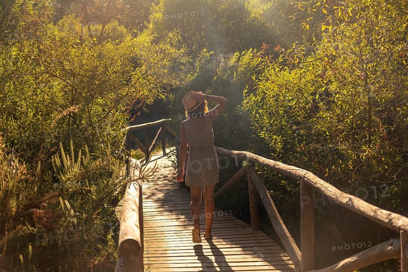 A young tourist on a wooden walkway in the Donana Natural Park