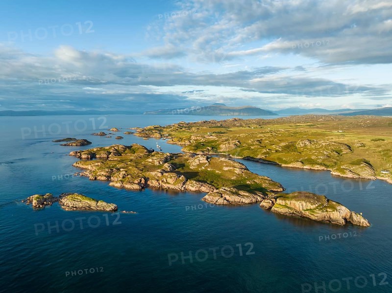 Aerial view of the coastline of the Ross of Mull peninsula with small islands