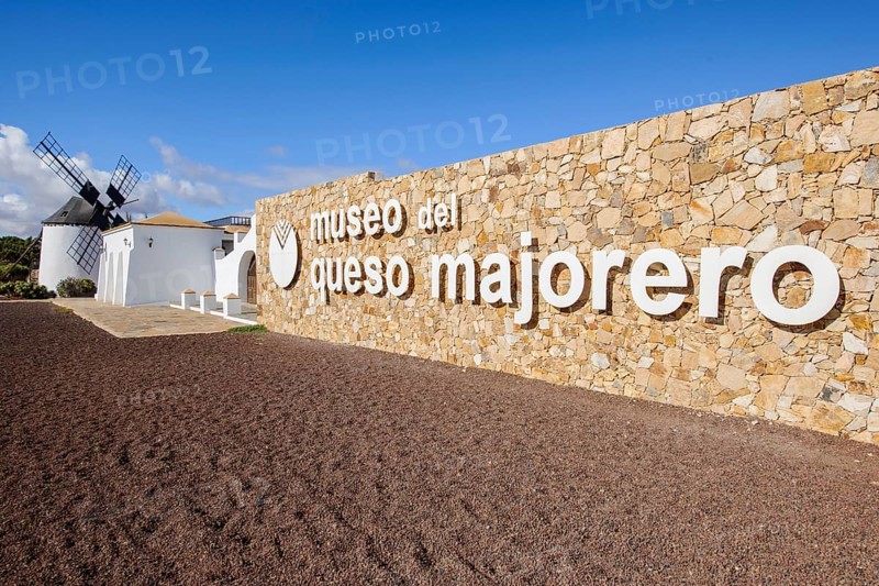 View of quarry stone wall with lettering Logo Museo del Queso Majorero Cheese Museum Majorero Cheese