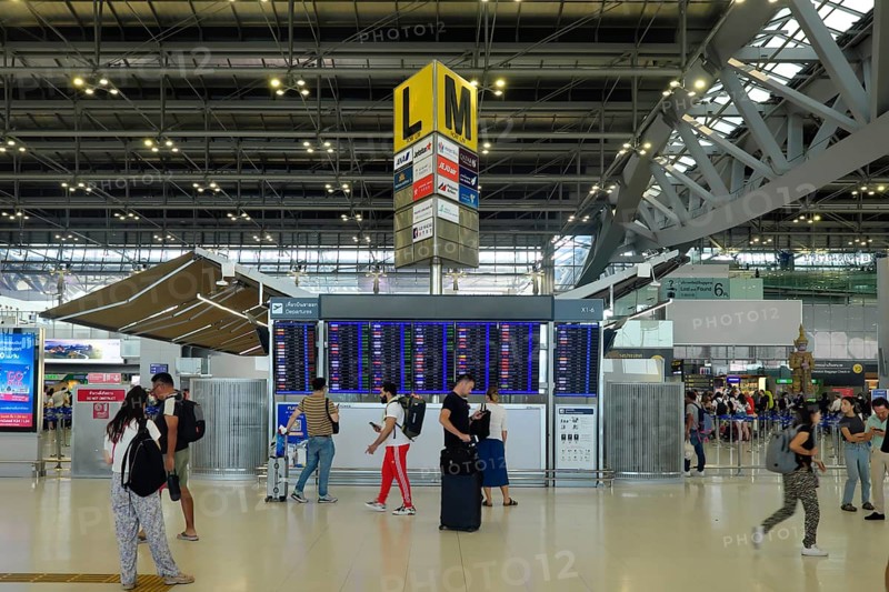 People in front of departure board
