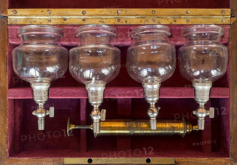 19th century Charriere cupping therapy set showing brass pump and four valved cupping glasses