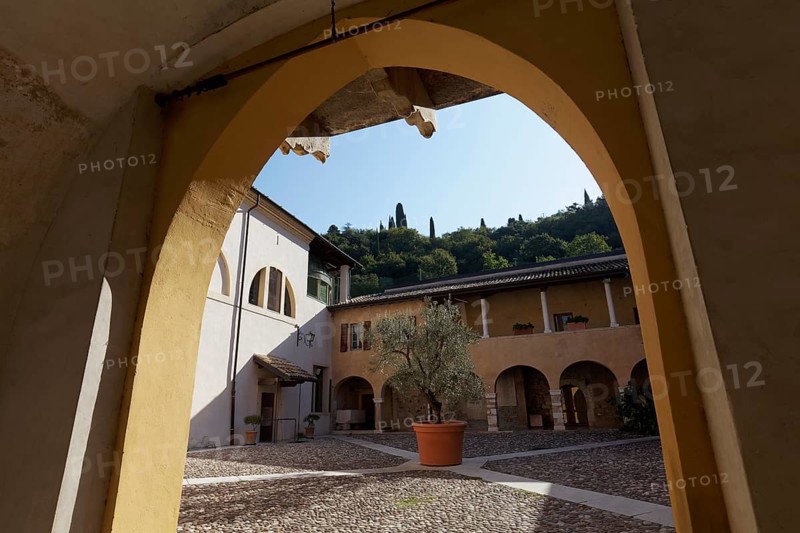 View through archway onto arcaded courtyard Chiostro della Pieve