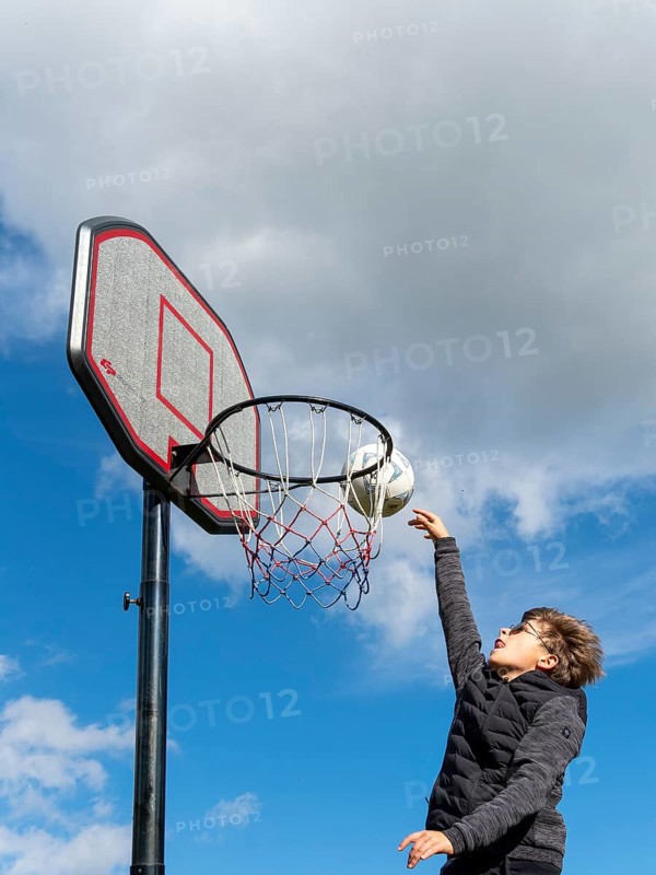 Basketball jumping with the ball to the basket and net