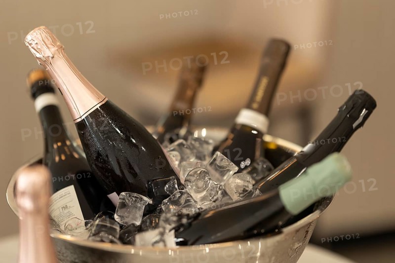 Bottles of champagne in a bucket filled with ice. Mid shot