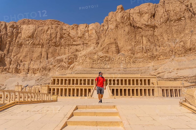 A young woman visiting the Mortuary Temple of Hatshepsut without people on her return from tourism in Luxor after the coronavirua pandemic