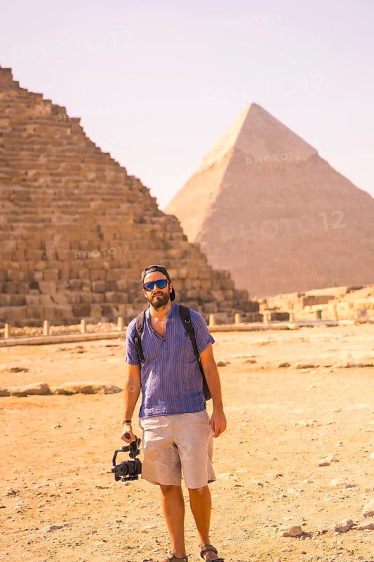 A young photographer at the pyramid of Cheops the largest pyramid. The pyramids of Giza the oldest funerary monument in the world. In the city of Cairo