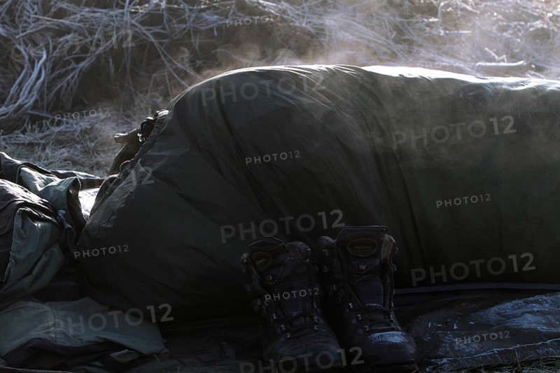A sleeping bag steams in the morning sun after a frosty night