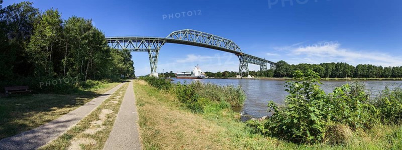Kiel Canal with Hochdonn railway bridge and container ship