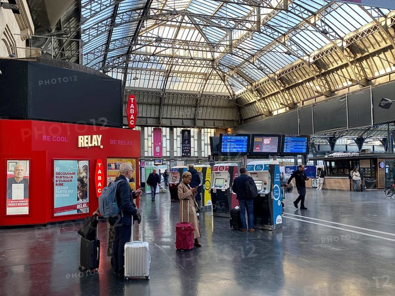 Travellers waiting in front of ticket counter
