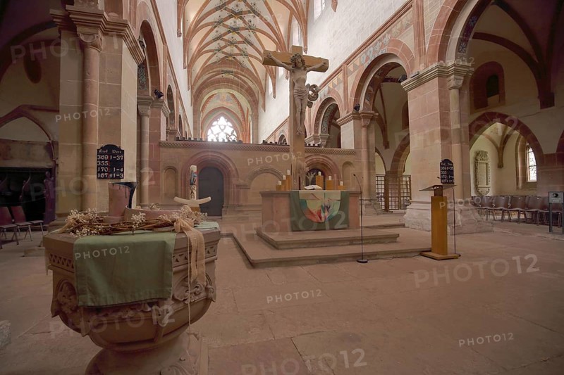 Interior view with baptismal font and crucifix of the monastery church and former Cistercian abbey