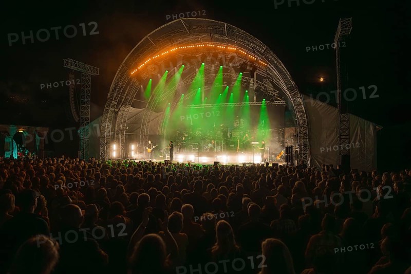 Crowd at Live Klostersommer Festival in Historic Monastery in front of stage