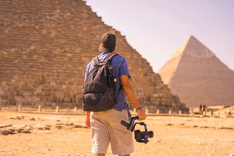 A young photographer at the pyramid of Cheops the largest pyramid. The pyramids of Giza the oldest funerary monument in the world. In the city of Cairo