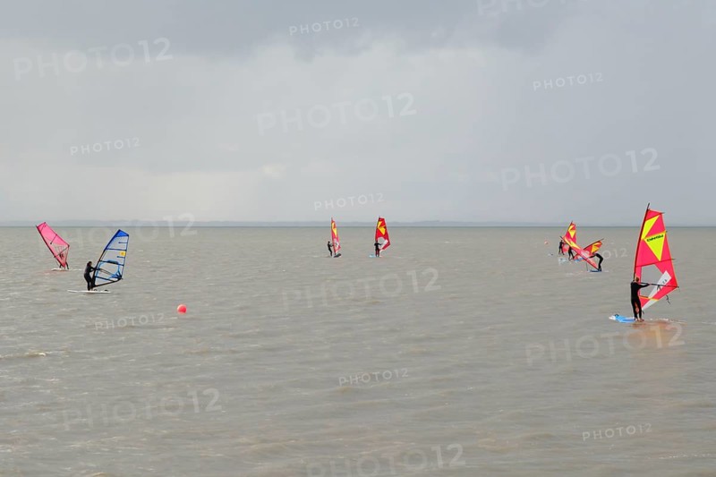 Surfers of a surf school on the sea