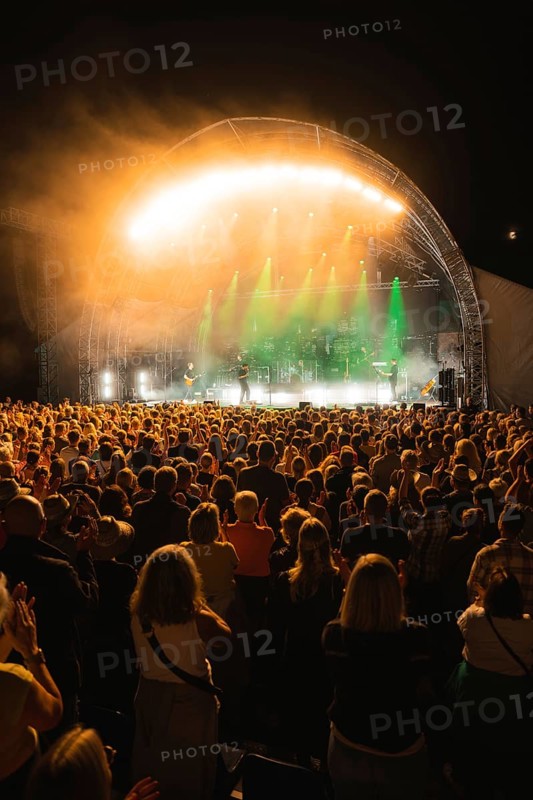 Crowd at Live Klostersommer Festival in Historic Monastery in front of stage