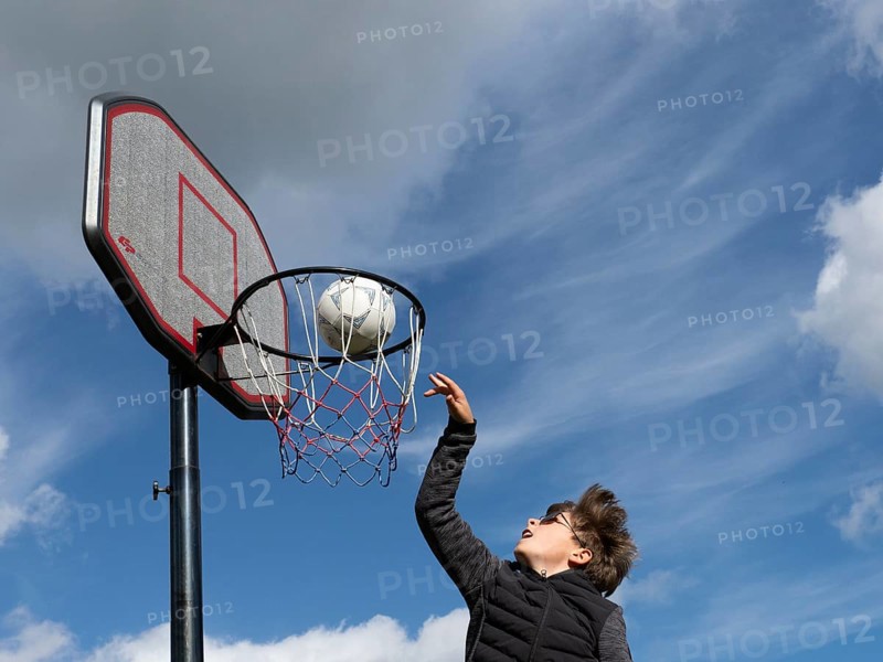 Basketball jumping with the ball to the basket and net
