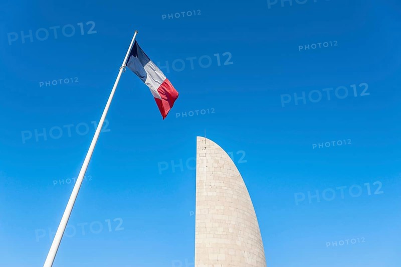 French national flag in front of the memorial Lighthouse of Remembrance at the former concentration camp Natzweiler-Struthof